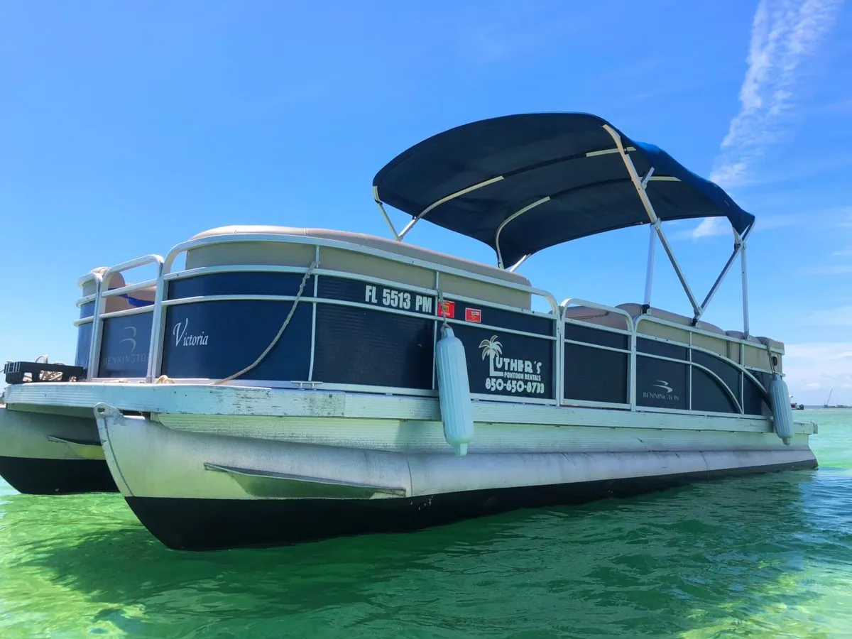 The 24ft pontoon boat “Victoria” anchored in bright turquoise water