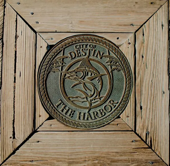 A wood-mounted “City of Destin, The Harbor” seal