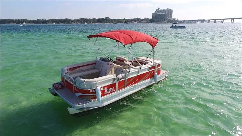 A red-topped 20ft pontoon boat docked at Luther's